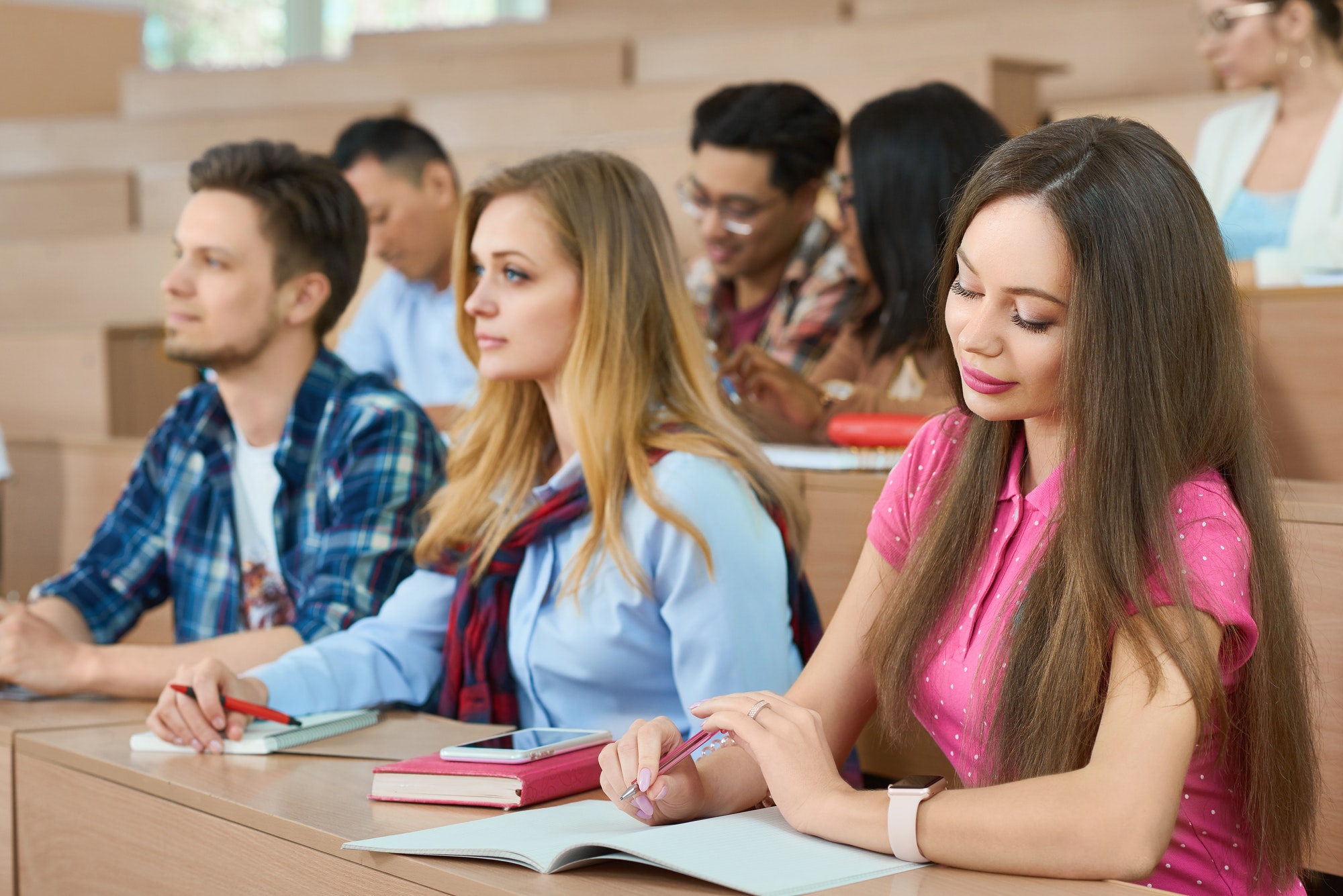 students-sitting-on-wooden-desks-in-classroom.jpg